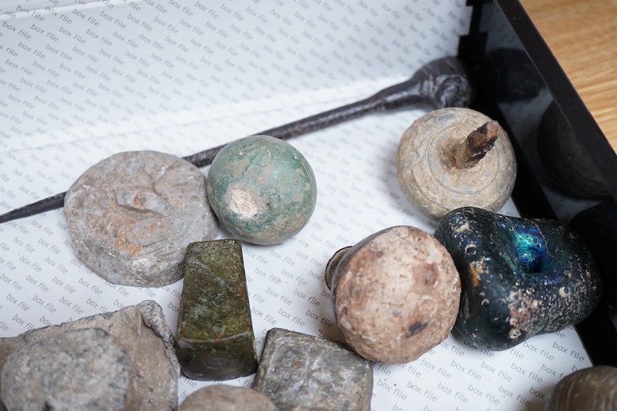 A collection of Roman and other ancient lead weights in various forms bearing various cast marks, together with a cast iron pointer the handle in the form of a head